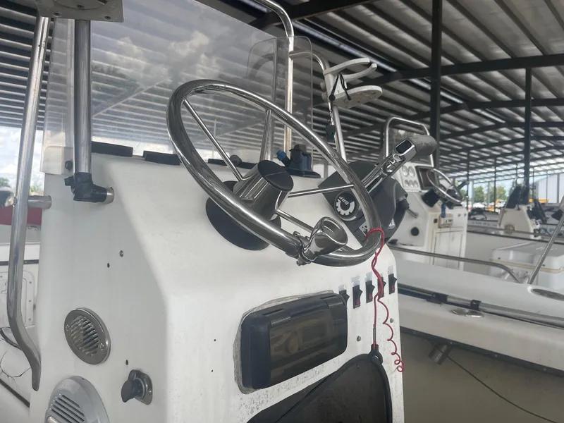 Slide: The Image of Close-up of 1997 Custom C Halk 18 boat steering console in a covered marina. - 7