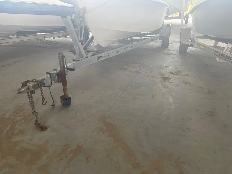 Slide: The Image of Boat trailer for Custom C Halk 18, 1997 model, in a storage facility. - 8