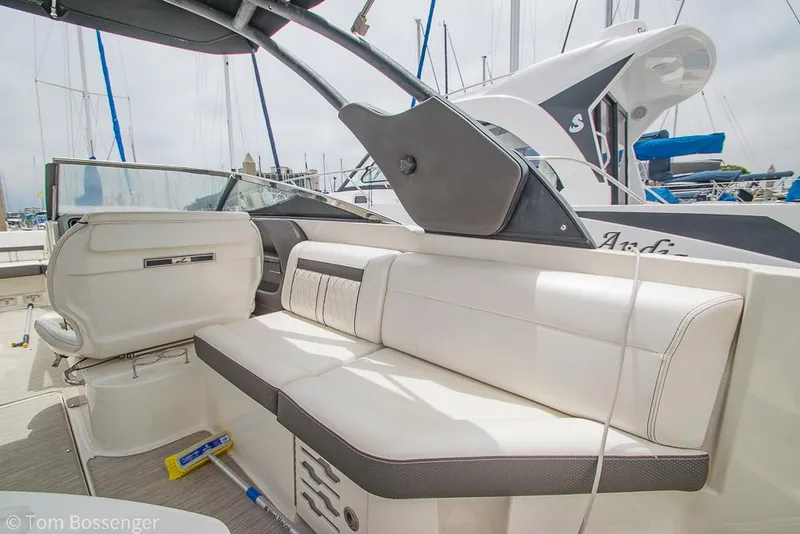 Slide: The Image of 2017 Sea Ray SLX 280 boat interior with white seating and modern design. - 11