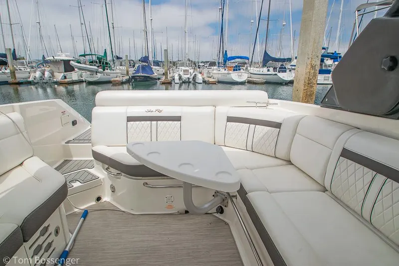 Slide: The Image of 2017 Sea Ray SLX 280 boat interior with seating and table, docked at marina. - 12