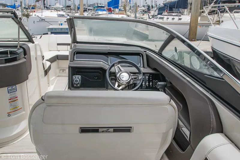 Slide: The Image of 2017 Sea Ray SLX 280 boat cockpit with steering wheel and dashboard controls. - 13