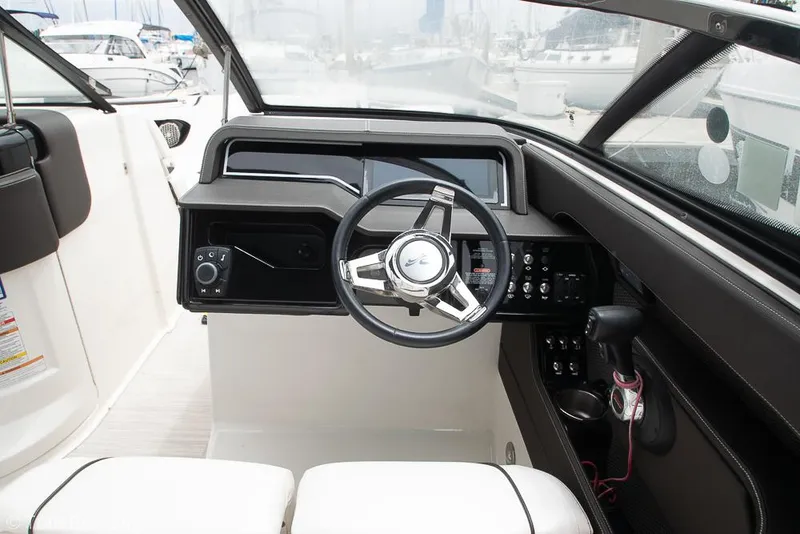 Slide: The Image of 2017 Sea Ray SLX 280 boat cockpit with steering wheel and control panel. - 16