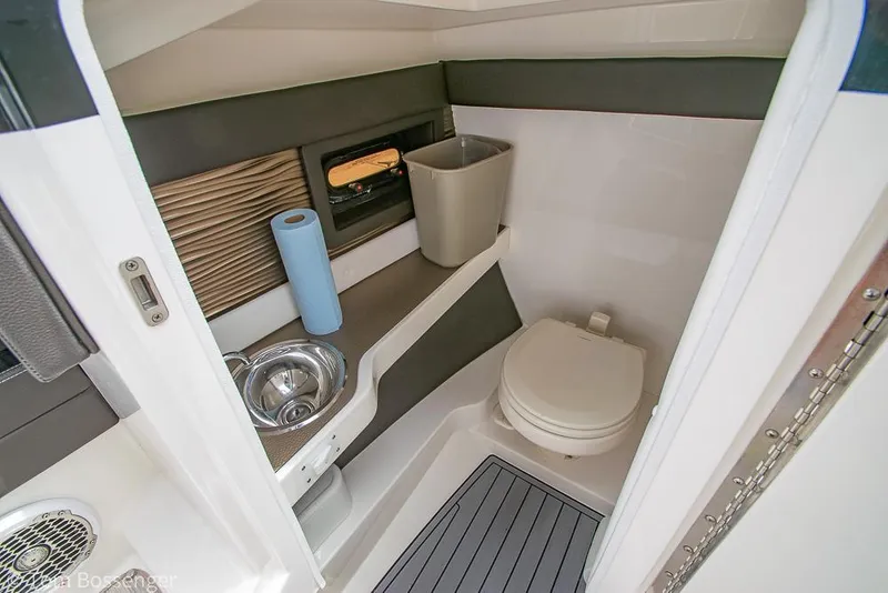 Slide: The Image of 2017 Sea Ray SLX 280 boat bathroom with sink, toilet, and storage. - 19