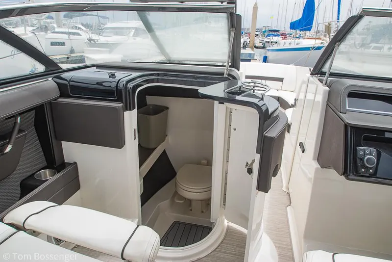 Slide: The Image of 2017 Sea Ray SLX 280 boat interior with open bathroom door, showcasing compact marine toilet. - 20