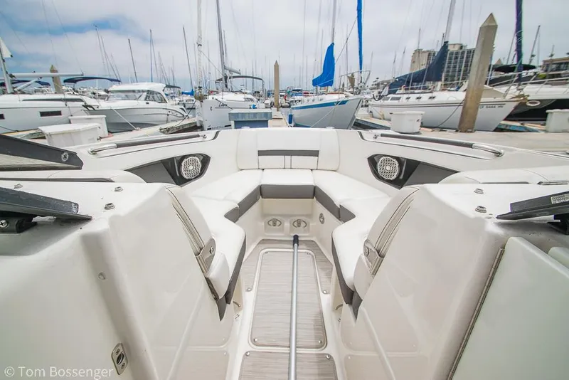 Slide: The Image of 2017 Sea Ray SLX 280 boat interior at marina, showcasing seating and docked yachts. - 21