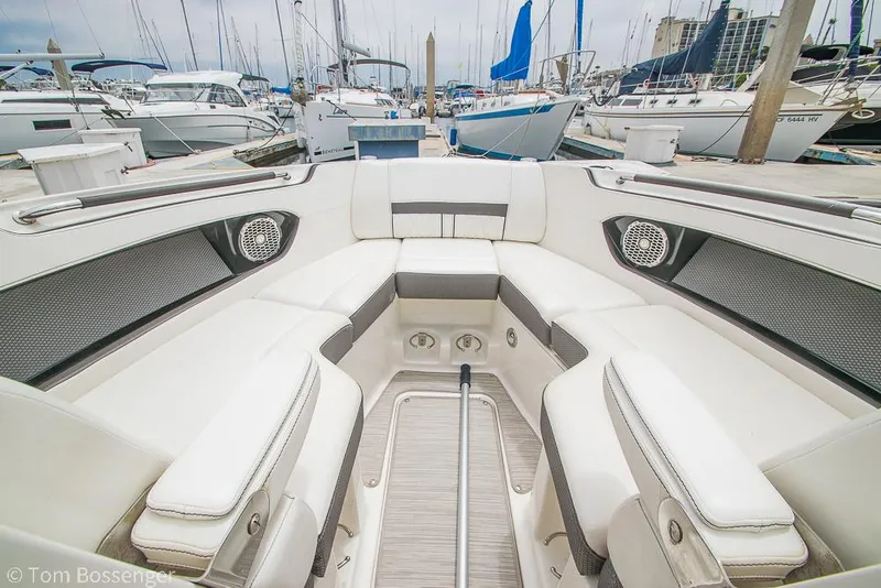 Slide: The Image of 2017 Sea Ray SLX 280 boat interior with white seating at marina. - 22