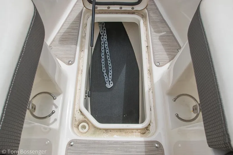 Slide: The Image of 2017 Sea Ray SLX 280 anchor storage compartment with chain visible. - 31