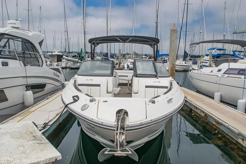 Slide: The Image of 2017 Sea Ray SLX 280 boat docked in a marina with other vessels. - 4