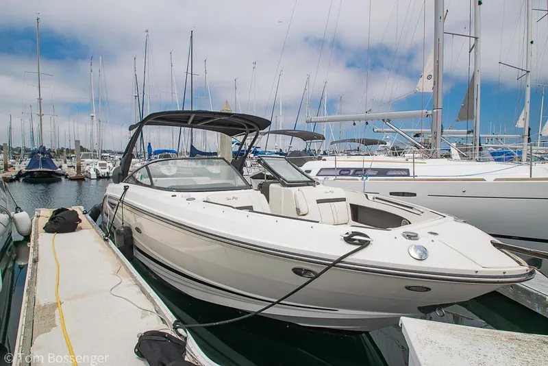 Slide: The Image of 2017 Sea Ray SLX 280 boat docked at a marina with sailboats in the background. - 5