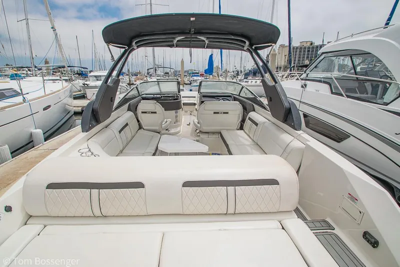 Slide: The Image of 2017 Sea Ray SLX 280 boat with spacious seating at a marina. - 7