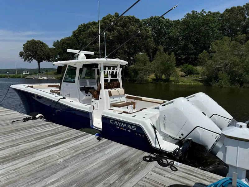 Slide: The Image of 2024 Caymas 34 CT boat docked by a lake. - 1