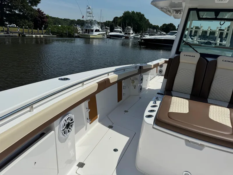 Slide: The Image of 2024 Caymas 34 CT boat interior with seating and waterfront view. - 10
