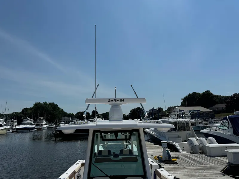 Slide: The Image of 2024 Caymas 34 CT boat docked at a marina with Garmin equipment. - 11