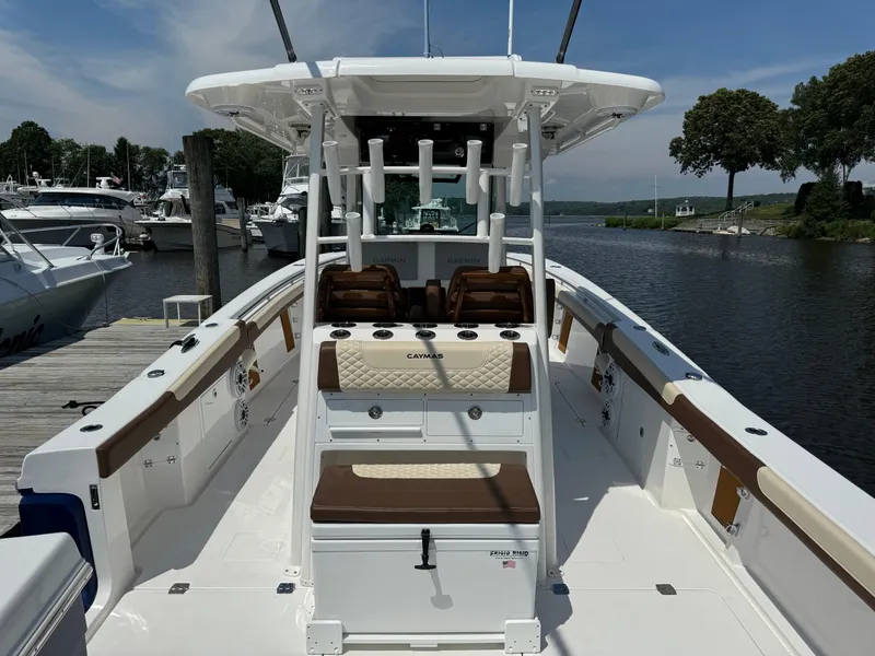Slide: The Image of 2024 Caymas 34 CT boat docked, featuring spacious seating and modern design. - 5