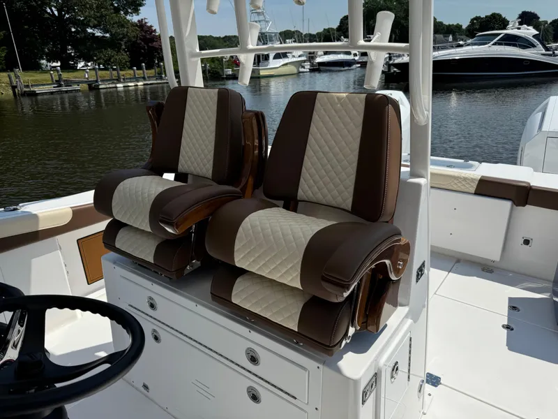Slide: The Image of 2024 Caymas 34 CT boat with luxurious dual captain's chairs on deck. - 6