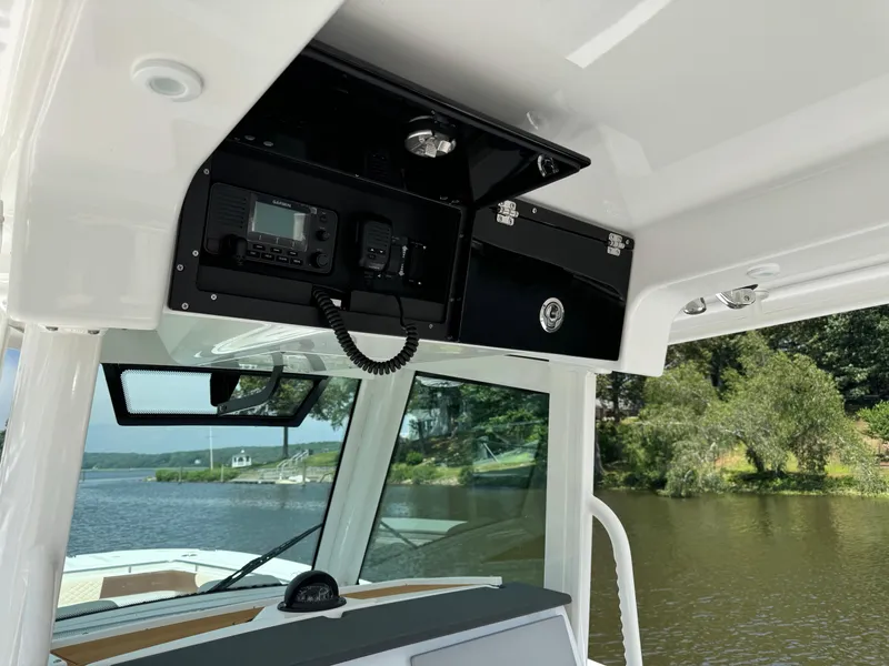 Slide: The Image of 2024 Caymas 34 CT boat interior with electronic equipment and scenic water view. - 7