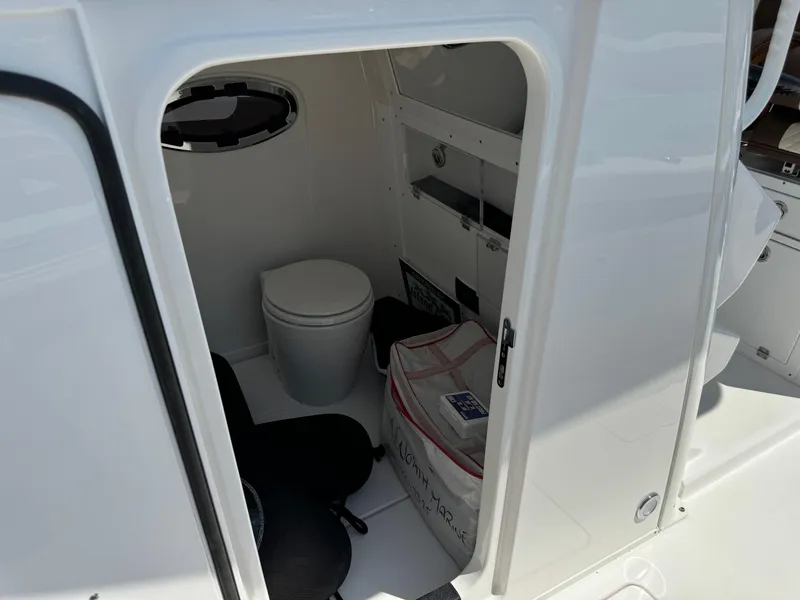 Slide: The Image of 2024 Caymas 34 CT boat interior with toilet and storage area. - 8