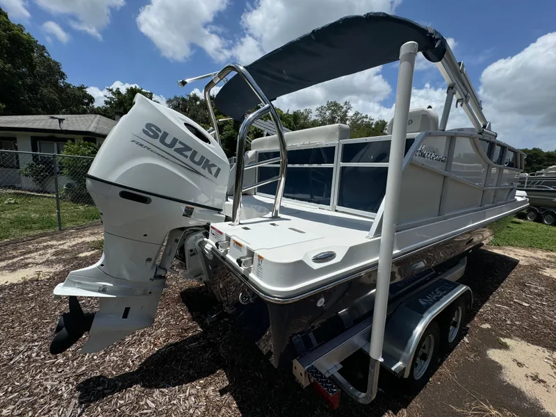 Slide: The Image of 2024 Hurricane FunDeck 2260 REF boat with Suzuki outboard motor on trailer. - 2