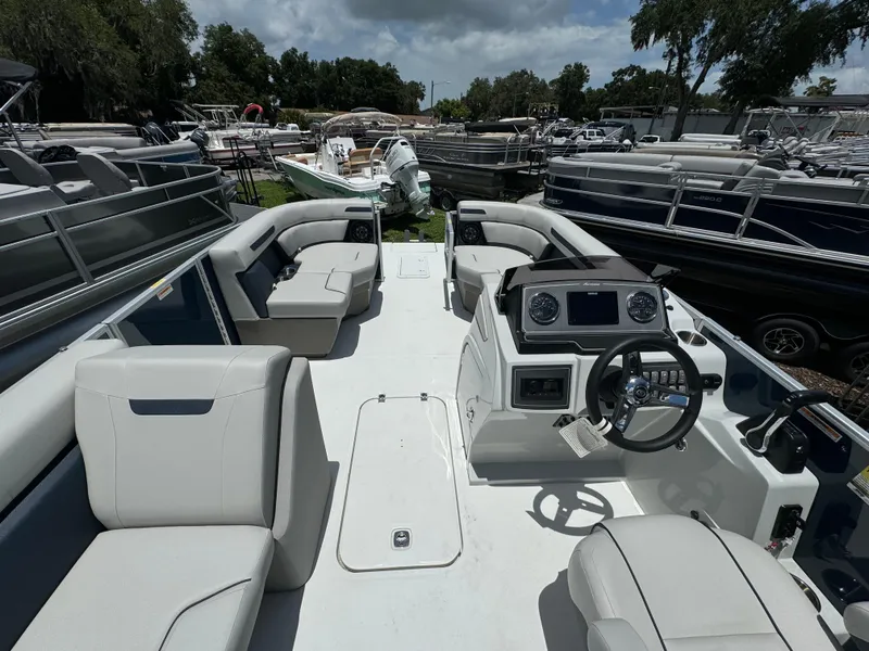 Slide: The Image of 2024 Hurricane FunDeck 2260 REF boat interior with spacious seating and modern dashboard. - 5