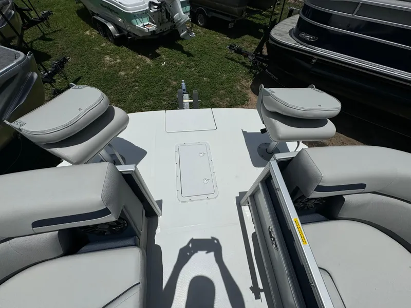 Slide: The Image of 2024 Hurricane FunDeck 2260 REF boat deck with seating and storage compartments. - 6