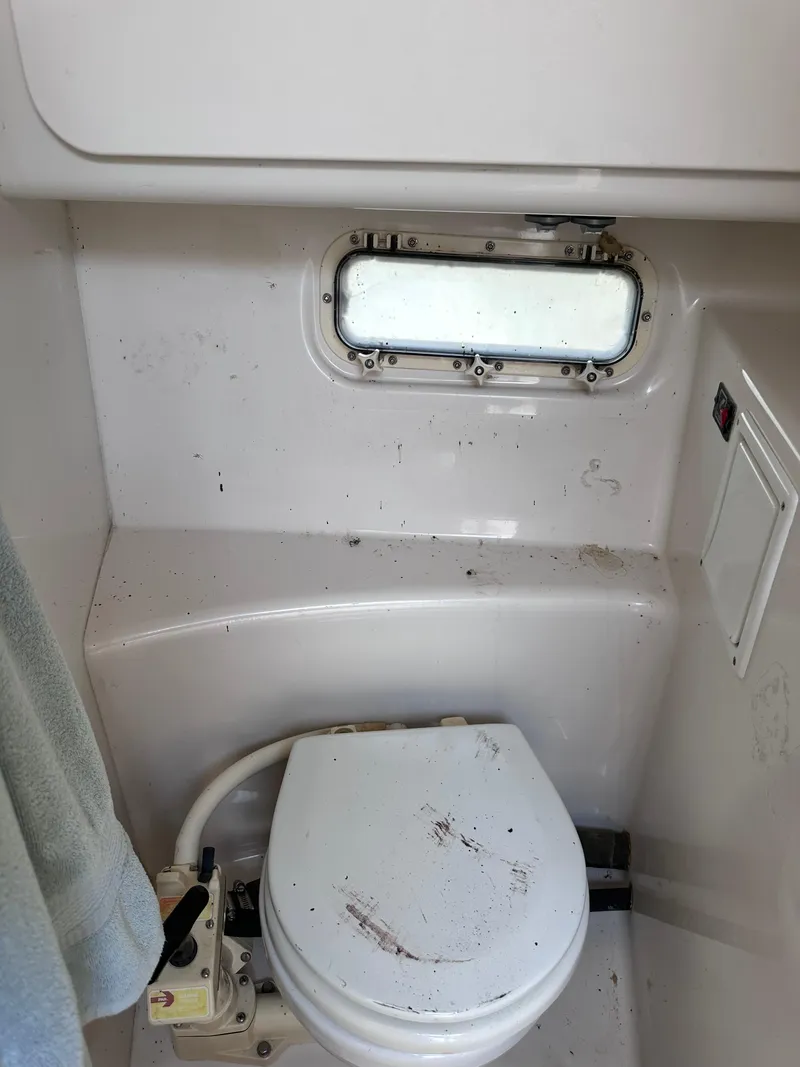 Slide: The Image of 1996 Maxum 2400 SCR boat bathroom with window and toilet - 10