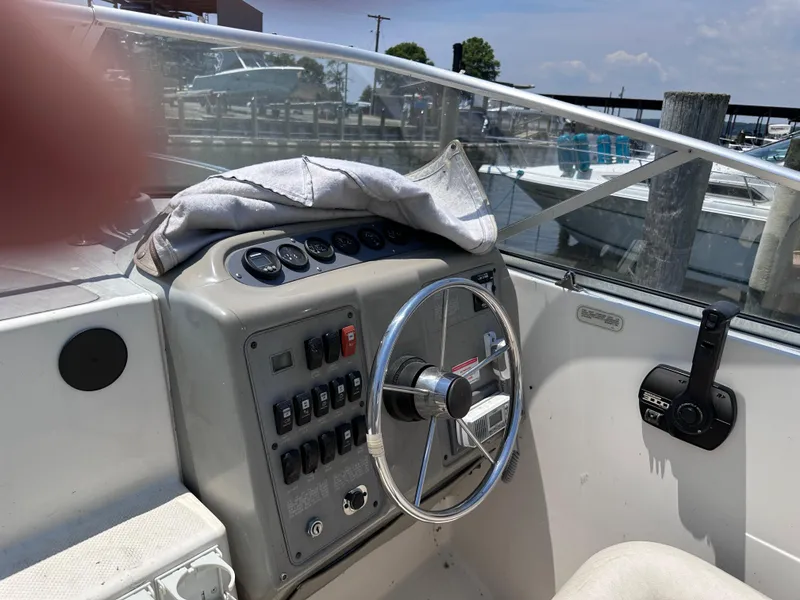 Slide: The Image of 1996 Maxum 2400 SCR boat cockpit with steering wheel and control panel. - 20