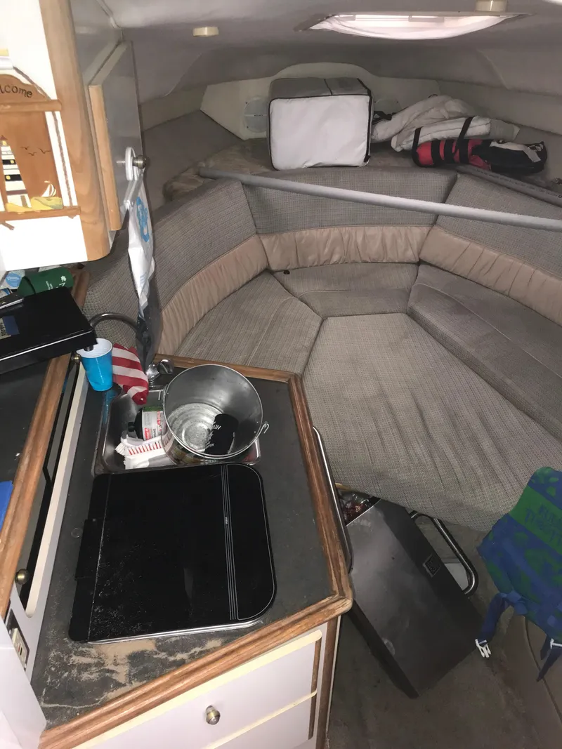 Slide: The Image of Interior cabin of a 1996 Maxum 2400 SCR boat with seating and kitchenette. - 23