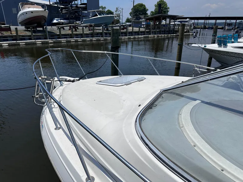 Slide: The Image of 1996 Maxum 2400 SCR boat docked at a marina. - 3