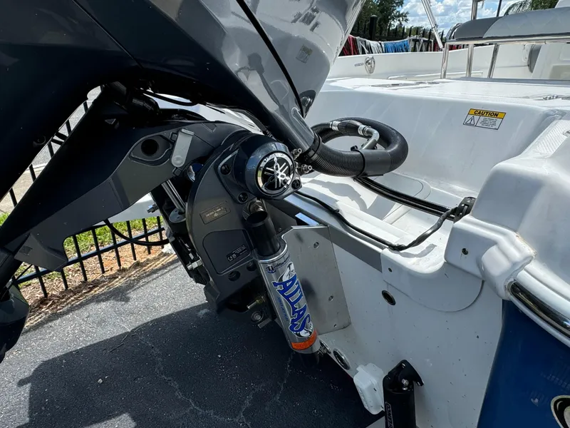 Slide: The Image of 2024 NauticStar 211 Hybrid boat engine and stern view. - 6