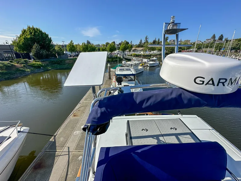 Slide: The Image of 2023 Targa 46 boat docked at a marina with clear blue skies. - 10