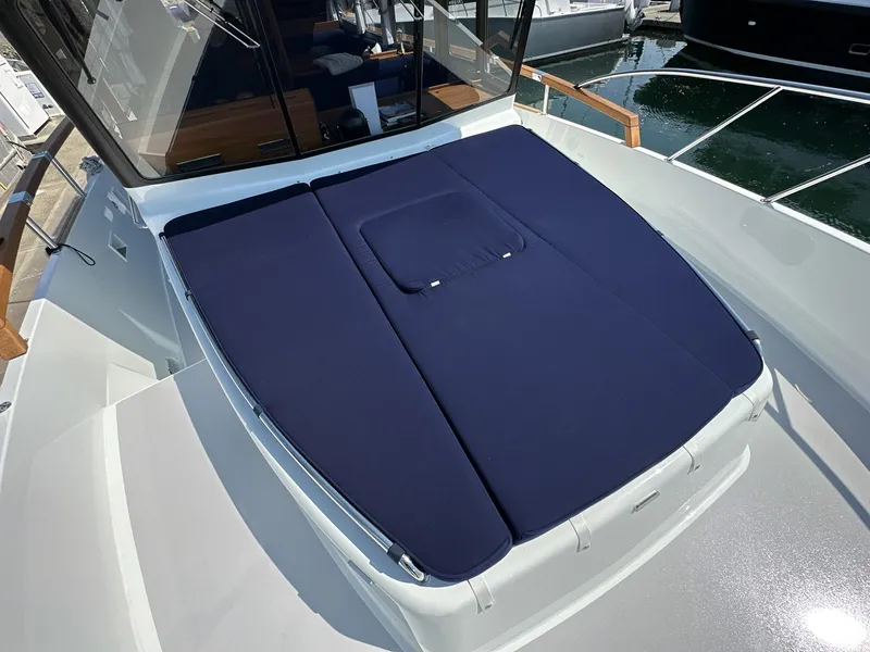 Slide: The Image of 2023 Targa 46 boat with blue sunbed cover on deck. - 11