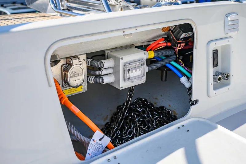 Slide: The Image of Electrical compartment of 2023 Targa 46 boat with cables and chains visible. - 13
