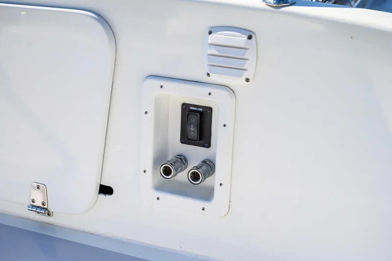 Slide: The Image of Control panel on a 2023 Targa 46 boat, featuring dual connectors and a vent. - 14