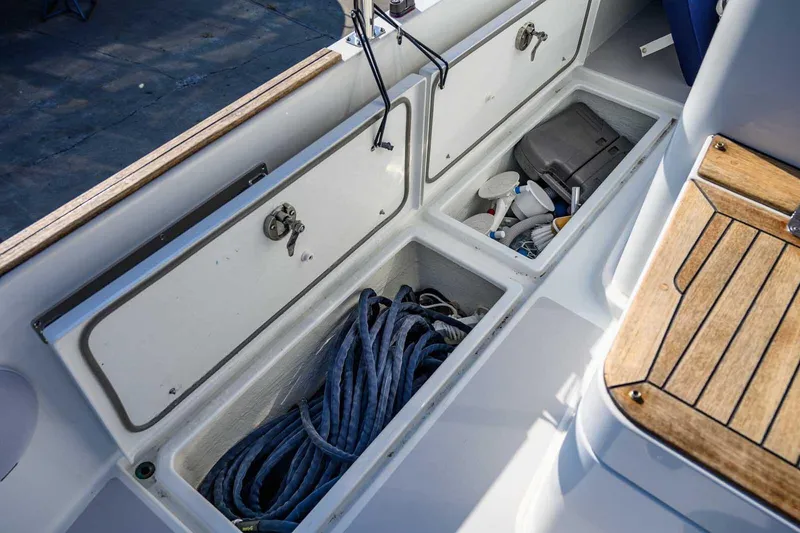 Slide: The Image of Storage compartments on a 2023 Targa 46 boat, featuring ropes and equipment. - 16