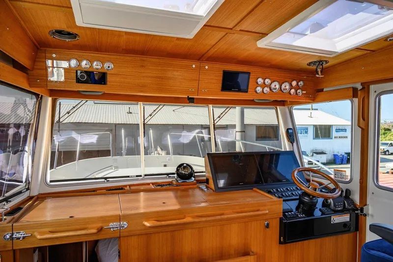 Slide: The Image of 2023 Targa 46 boat interior with wooden dashboard and modern navigation equipment. - 18