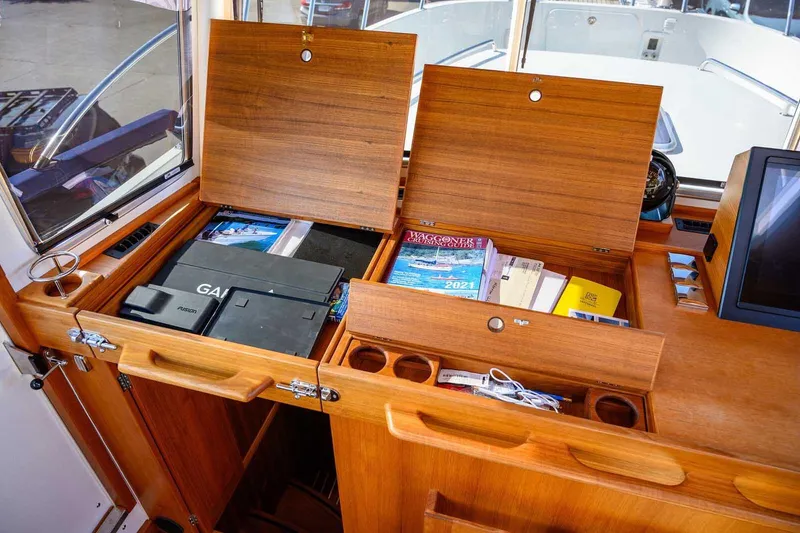 Slide: The Image of Interior of 2023 Targa 46 yacht with wooden storage compartments and navigation equipment. - 19