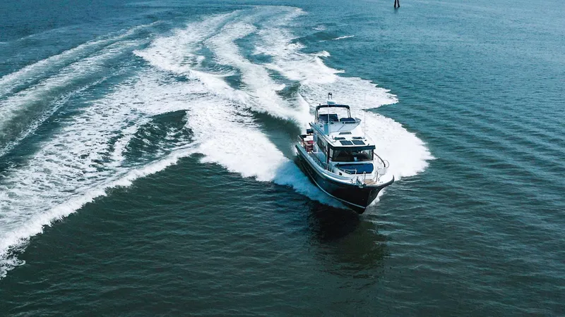 Slide: The Image of 2023 Targa 46 boat cruising on open water, leaving a wake behind. - 2