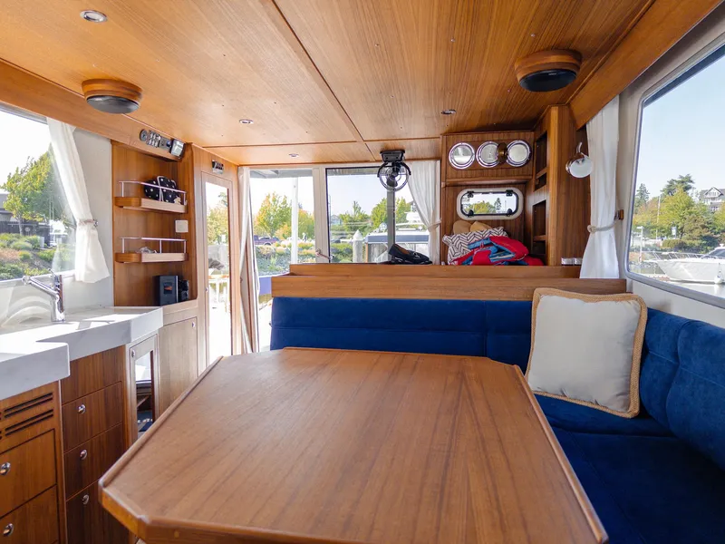 Slide: The Image of Interior of 2023 Targa 46 boat with wooden furnishings and blue seating. - 20