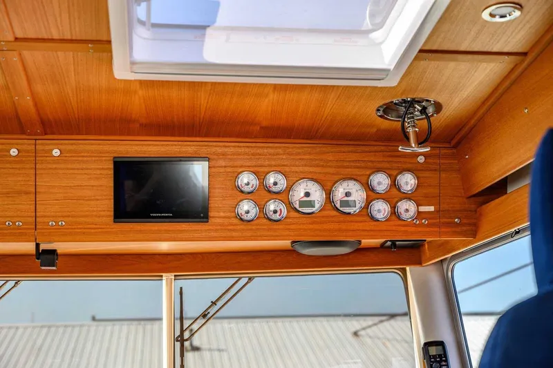 Slide: The Image of 2023 Targa 46 boat dashboard with gauges and a Volvo Penta display. - 21