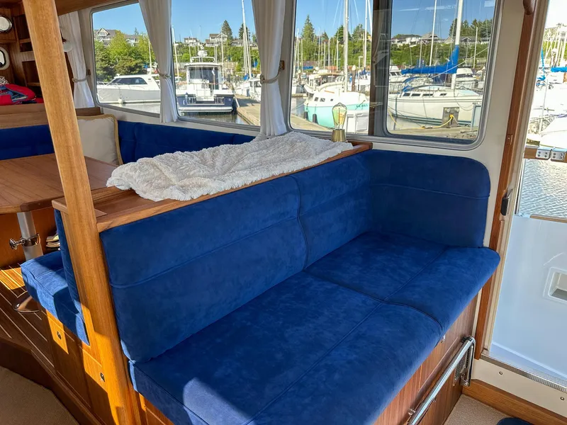 Slide: The Image of Interior of 2023 Targa 46 boat with blue seating and marina view. - 23