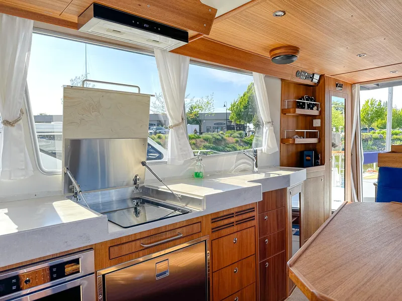 Slide: The Image of Luxurious Targa 46 yacht interior kitchen with modern appliances and wooden cabinetry, 2023 model. - 24