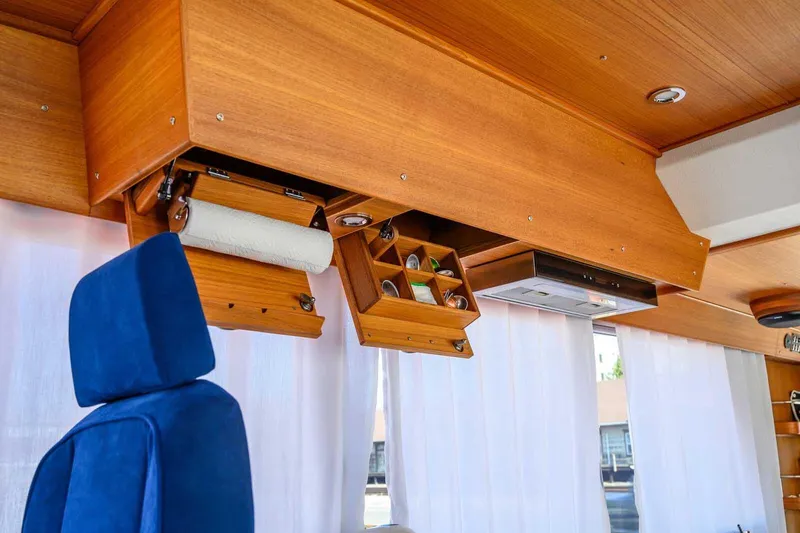 Slide: The Image of Interior of 2023 Targa 46 yacht with wooden cabinets and blue seating. - 25