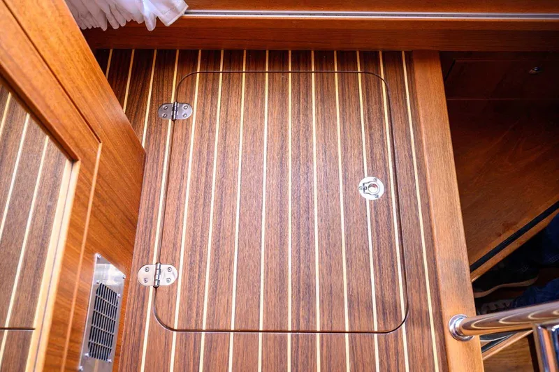 Slide: The Image of Wooden hatch on Targa 46 boat floor, 2023 model, featuring sleek striped design. - 29