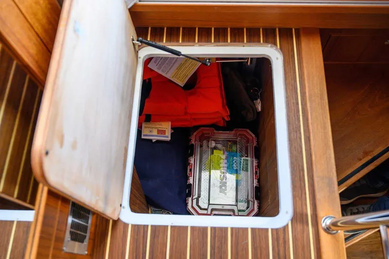 Slide: The Image of Storage compartment on 2023 Targa 46 boat with safety gear and equipment. - 30