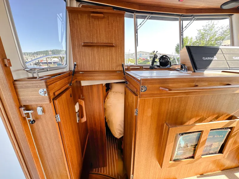 Slide: The Image of Interior of 2023 Targa 46 boat with wooden cabinetry and navigation equipment. - 31