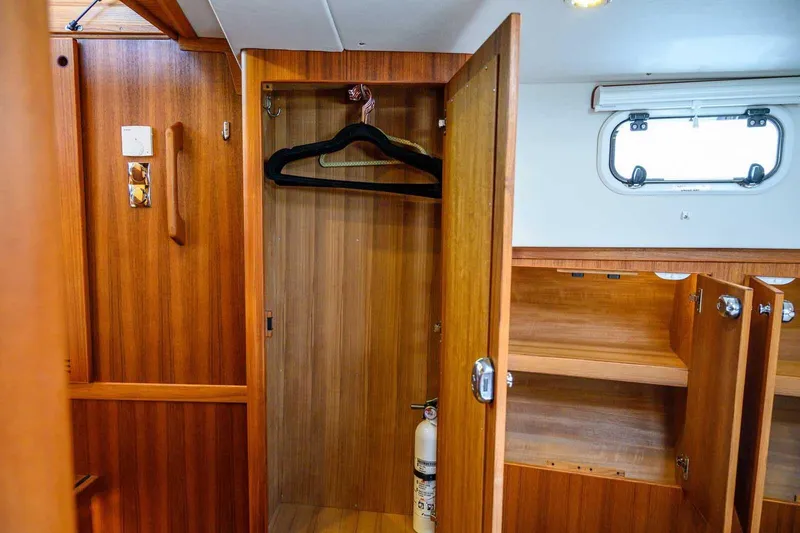 Slide: The Image of Wooden interior of 2023 Targa 46 yacht with open closet and storage compartments. - 35