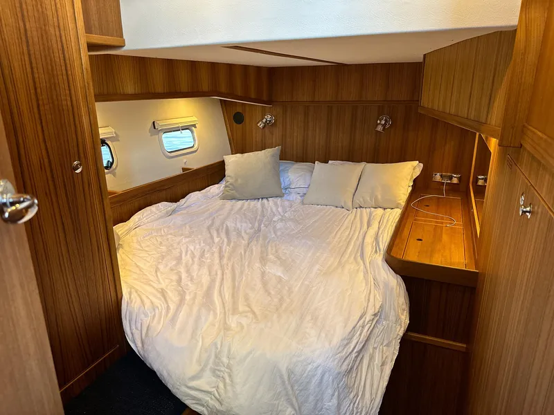 Slide: The Image of Luxurious cabin interior of 2023 Targa 46 yacht with cozy bed and wooden finish. - 38