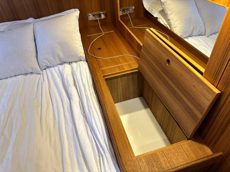 Slide: The Image of Wooden storage compartment beside bed in 2023 Targa 46 yacht cabin. - 39