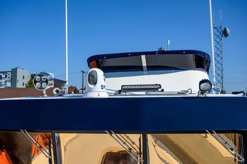 Slide: The Image of 2023 Targa 46 boat with advanced navigation equipment under clear blue sky. - 5