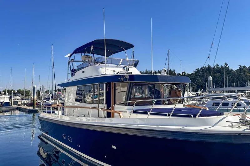 Slide: The Image of 2023 Targa 46 yacht docked in marina under clear blue sky. - 7